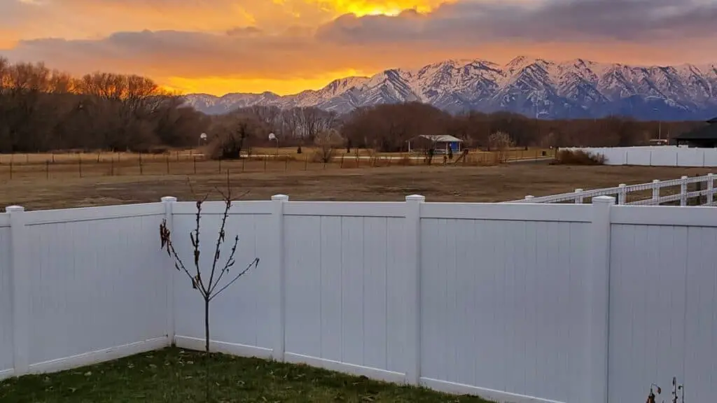 vinyl-fence-sunset-sky-snow-capped-mountains-in-background